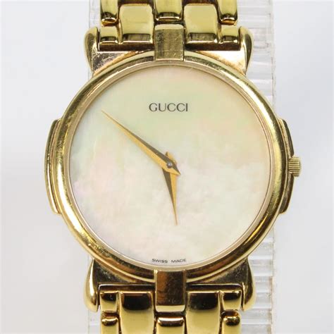 ladies gucci gold mother of pearl watch|Gucci watch interchangeable faces.